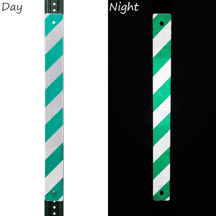 Two white reflectors on a green post indicates